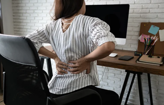 Female at desk with lower back pain